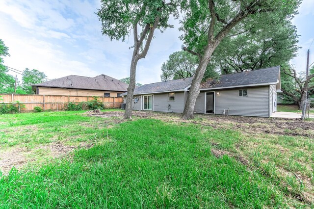 rear view of property featuring fence