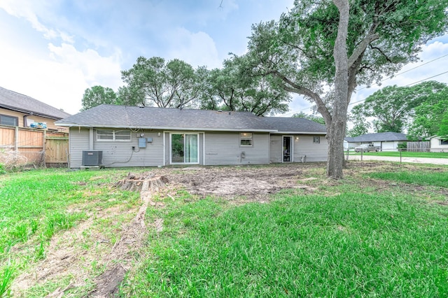 rear view of property with fence and central AC unit
