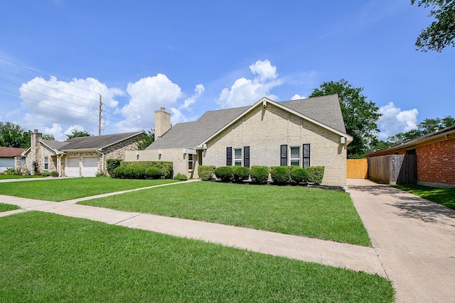 single story home with a front lawn, brick siding, a chimney, concrete driveway, and fence
