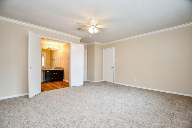 unfurnished bedroom with crown molding, visible vents, carpet, and baseboards