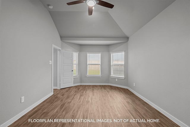 spare room featuring baseboards, wood finished floors, a ceiling fan, and vaulted ceiling