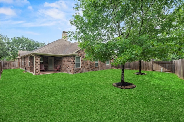 view of yard with a fenced backyard and a patio area