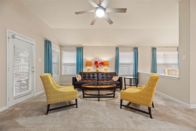 living area featuring a ceiling fan, carpet flooring, vaulted ceiling, and baseboards