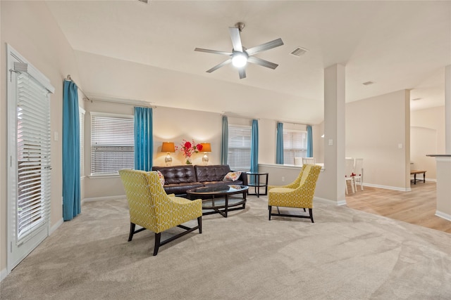 carpeted living room with visible vents, a ceiling fan, and baseboards