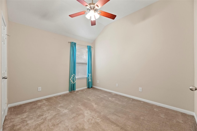 carpeted empty room with lofted ceiling, ceiling fan, and baseboards