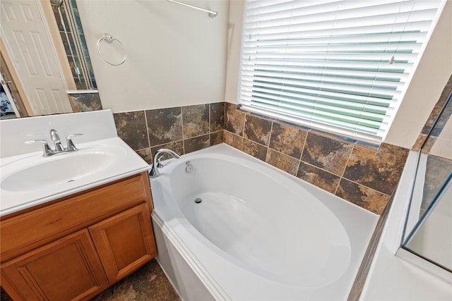 bathroom featuring a bath and vanity