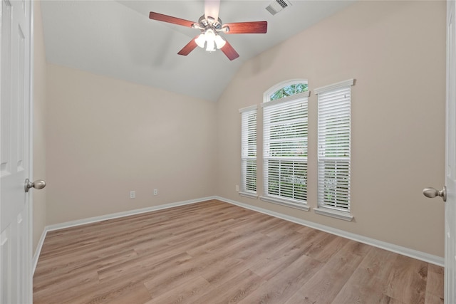 empty room featuring lofted ceiling, visible vents, baseboards, light wood finished floors, and a ceiling fan