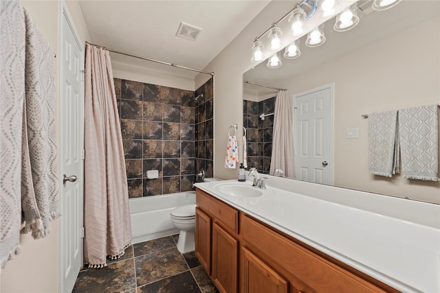full bathroom featuring shower / bath combo, vanity, toilet, visible vents, and stone finish floor