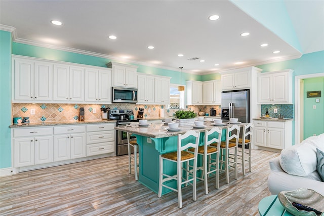 3347 Prides Way, Crystal Beach, TX 77650 - kitchen featuring a kitchen breakfast bar, white cabinetry, stainless steel appliances, and crown molding