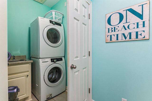 3347 Prides Way, Crystal Beach, TX 77650 - laundry area with stacked washing maching and dryer, light tile patterned floors, cabinet space, and a sink