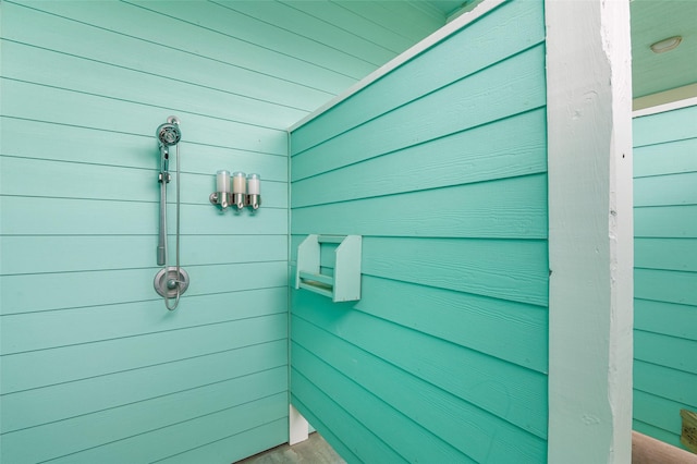3347 Prides Way, Crystal Beach, TX 77650 - bathroom featuring wood walls and tiled shower