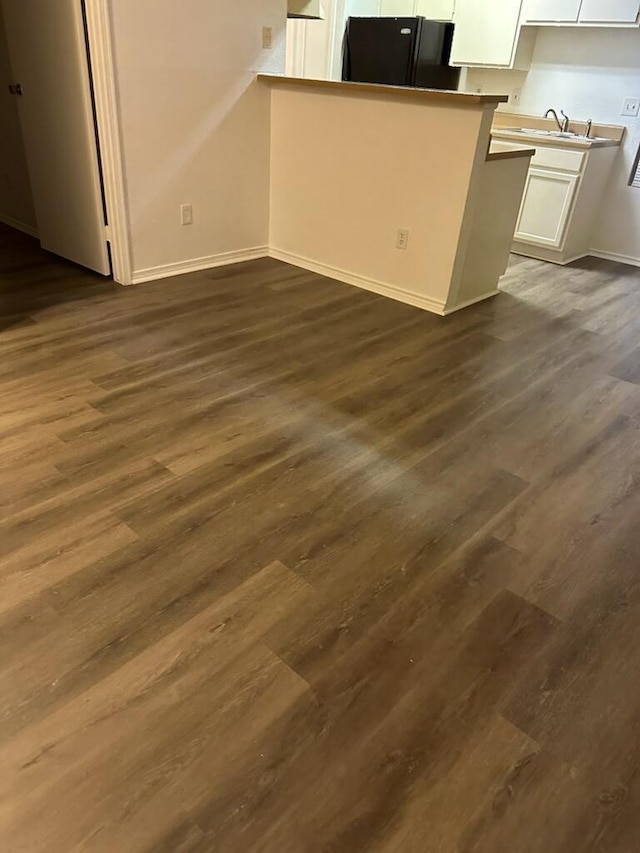 12660 Ashford Point Dr Unit 403, Houston, TX 77082 - interior space with a sink, baseboards, and dark wood finished floors