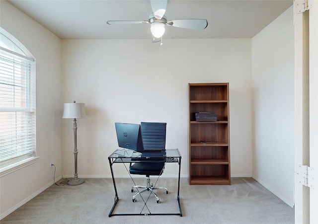 office area featuring a ceiling fan, carpet flooring, and baseboards