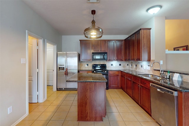 kitchen featuring dark stone countertops, black appliances, decorative backsplash, and a sink
