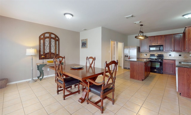 dining space featuring light tile patterned flooring, visible vents, and baseboards