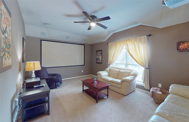 carpeted home theater with baseboards, visible vents, ceiling fan, and lofted ceiling