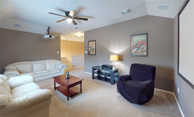 living area with ceiling fan, visible vents, vaulted ceiling, light carpet, and baseboards
