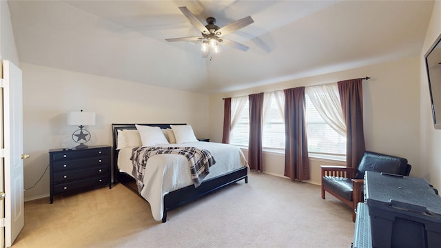 bedroom featuring ceiling fan, light colored carpet, and baseboards