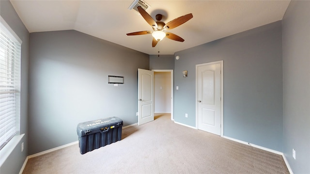 unfurnished room with carpet, ceiling fan, a healthy amount of sunlight, and visible vents
