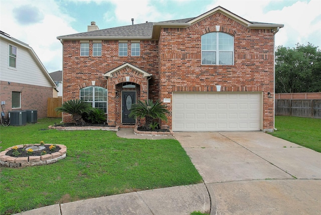 traditional-style house featuring a front yard, fence, a garage, and brick siding