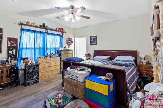 bedroom featuring wood finished floors and ceiling fan