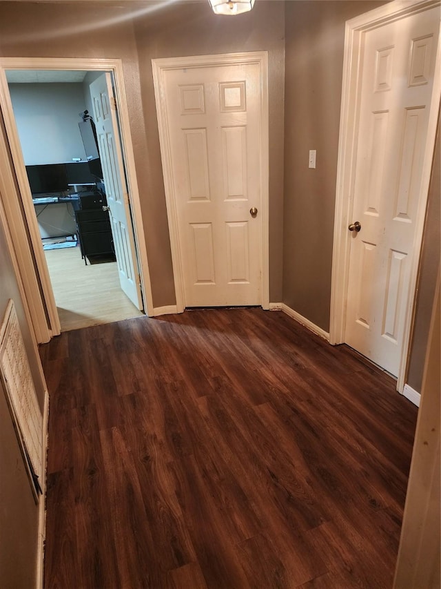 9316 Tejas Ct, La Porte, TX 77571 - hallway with baseboards and dark wood finished floors