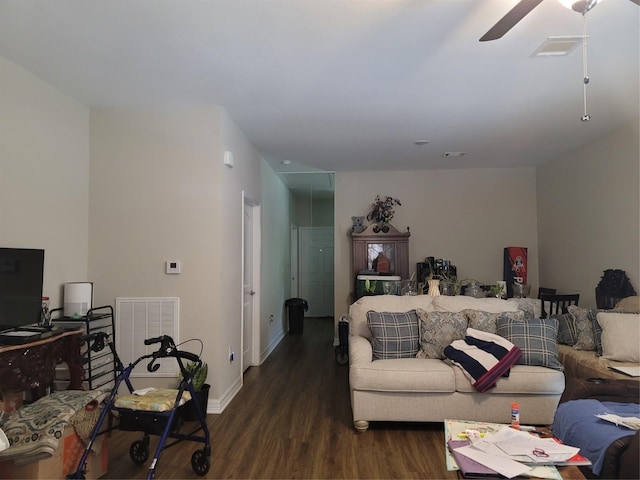 living area featuring baseboards, visible vents, wood finished floors, and a ceiling fan