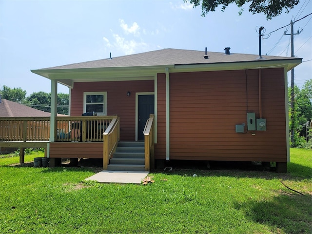rear view of property with a lawn and a deck