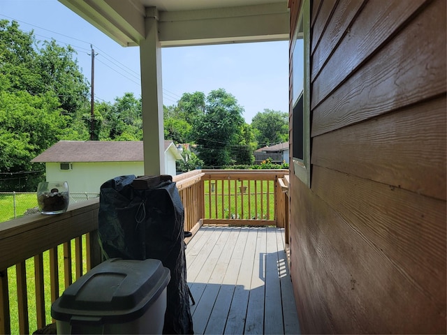 wooden deck with a yard and fence