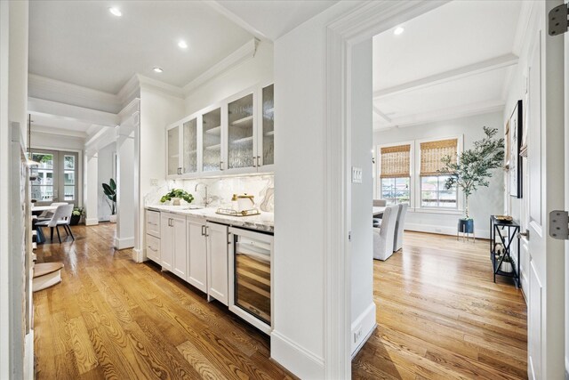 412 Redan St, Houston, TX 77009 - indoor bar featuring wine cooler, ornamental molding, healthy amount of natural light, light wood-type flooring, and recessed lighting