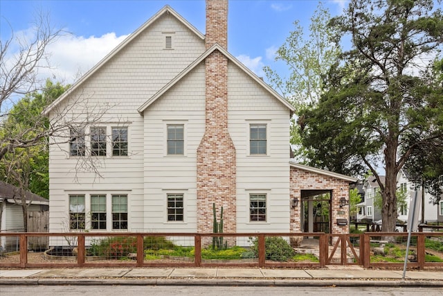 412 Redan St, Houston, TX 77009 - view of side of home with a fenced front yard and a chimney