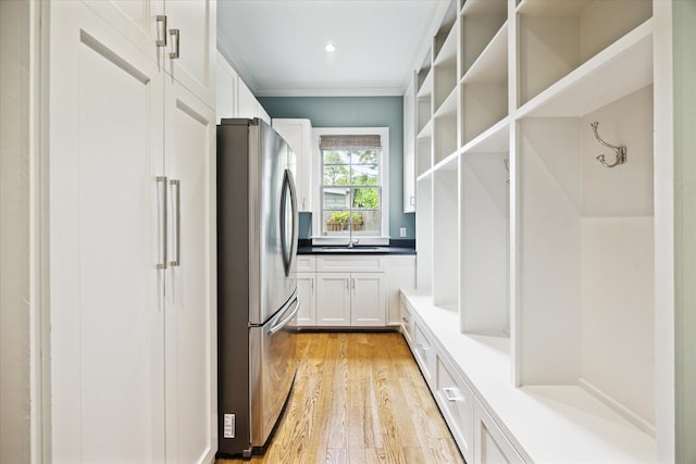 412 Redan St, Houston, TX 77009 - mudroom featuring light wood-type flooring, a sink, ornamental molding, and recessed lighting