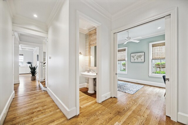 412 Redan St, Houston, TX 77009 - hallway with ornamental molding, light wood finished floors, baseboards, and recessed lighting