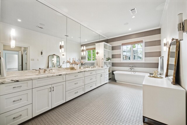 412 Redan St, Houston, TX 77009 - full bath with double vanity, a freestanding tub, ornamental molding, tile patterned floors, and recessed lighting