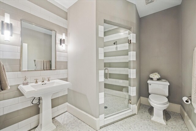412 Redan St, Houston, TX 77009 - bathroom with toilet, a stall shower, tile patterned floors, and baseboards