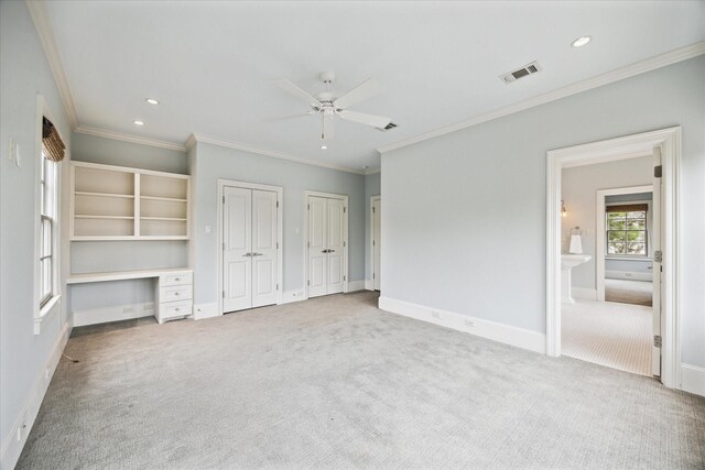 412 Redan St, Houston, TX 77009 - unfurnished bedroom featuring carpet, two closets, ornamental molding, recessed lighting, and baseboards