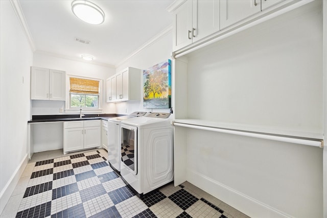 412 Redan St, Houston, TX 77009 - laundry area featuring independent washer and dryer, crown molding, baseboards, light tile patterned floors, and cabinet space