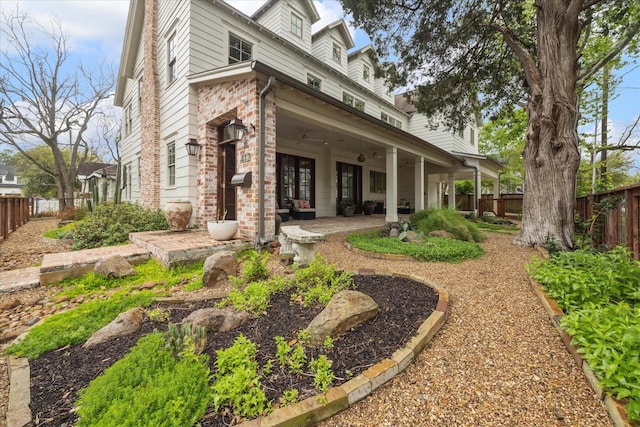 412 Redan St, Houston, TX 77009 - back of property featuring a fenced backyard, a patio area, and brick siding