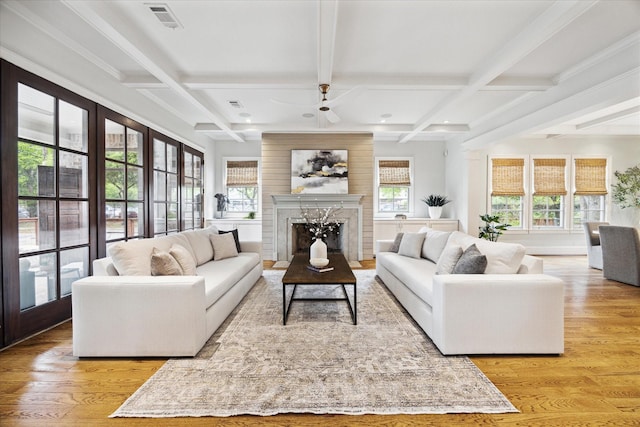 412 Redan St, Houston, TX 77009 - living room featuring light wood-type flooring, coffered ceiling, ceiling fan, beam ceiling, and a fireplace