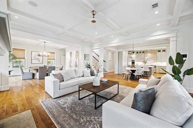 412 Redan St, Houston, TX 77009 - living area with light wood finished floors, coffered ceiling, beamed ceiling, a chandelier, and stairway