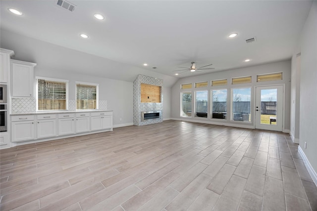 9306 Eckert Rd, Iowa Colony, TX 77583 - unfurnished living room with recessed lighting, a fireplace, baseboards, visible vents, and a ceiling fan