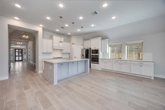 9306 Eckert Rd, Iowa Colony, TX 77583 - kitchen featuring white cabinetry, visible vents, plenty of natural light, and decorative backsplash