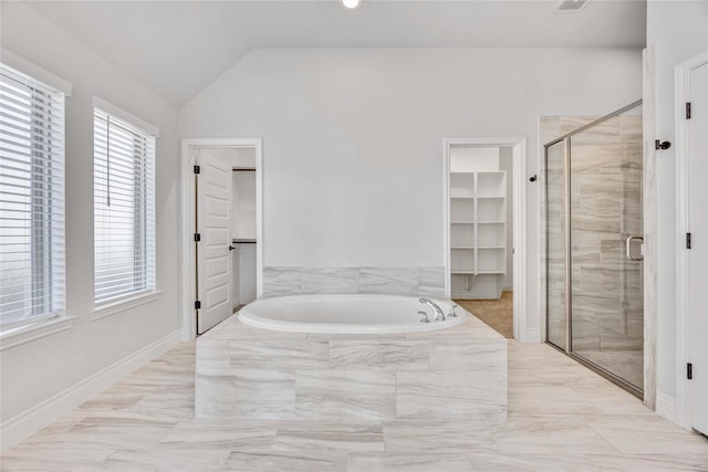 9306 Eckert Rd, Iowa Colony, TX 77583 - full bathroom with marble finish floor, a bath, a spacious closet, a stall shower, and lofted ceiling