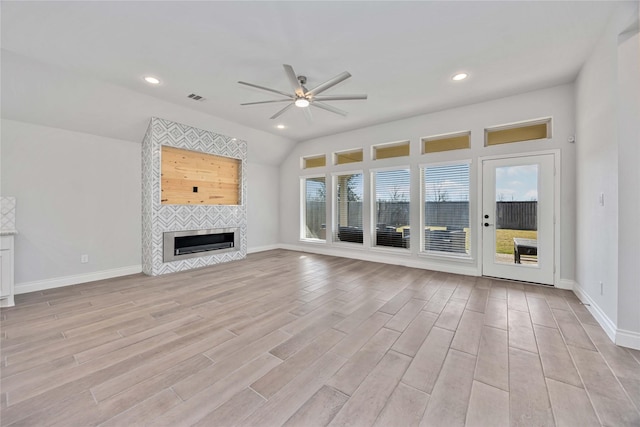 9306 Eckert Rd, Iowa Colony, TX 77583 - unfurnished living room with visible vents, ceiling fan, baseboards, a tile fireplace, and light wood-type flooring
