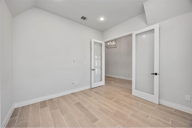 9306 Eckert Rd, Iowa Colony, TX 77583 - empty room with an inviting chandelier, wood finished floors, visible vents, and french doors