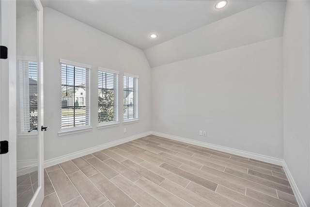 9306 Eckert Rd, Iowa Colony, TX 77583 - spare room with baseboards, recessed lighting, light wood-type flooring, and vaulted ceiling