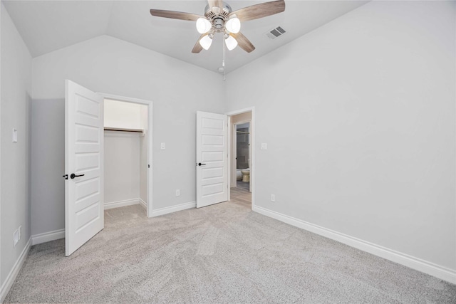 9306 Eckert Rd, Iowa Colony, TX 77583 - unfurnished bedroom featuring lofted ceiling, visible vents, baseboards, carpet, and a walk in closet