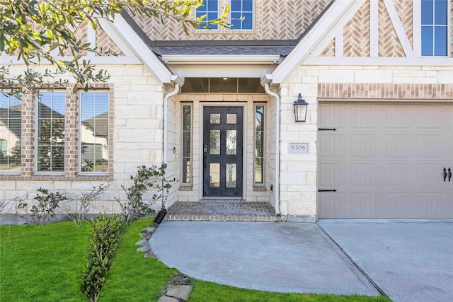 9306 Eckert Rd, Iowa Colony, TX 77583 - view of exterior entry with driveway, an attached garage, and stone siding