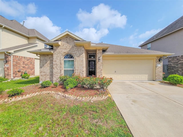 view of front of home featuring driveway, brick siding, and a garage