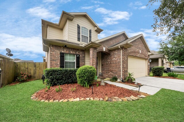 traditional-style house featuring a front yard, a garage, driveway, brick siding, and fence
